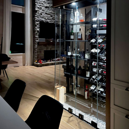 An illuminated wine display case that both delimits esapces and creates a tasting area.