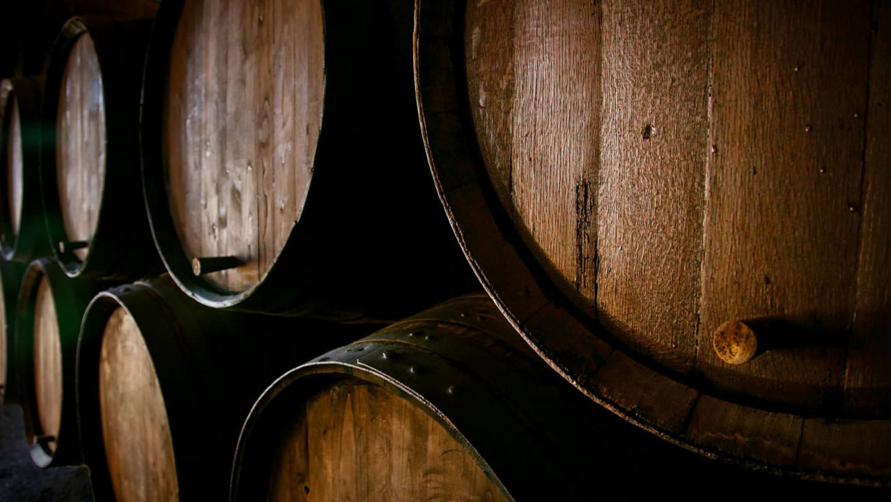 Photo of barrels where wine is aged in the winemaker’s cellar before bottling.