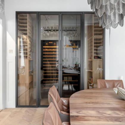 Compact wine storage solution integrated into a modern Scandinavian glass display.